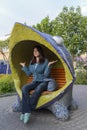 Woman relaxes on a funny bench Royalty Free Stock Photo