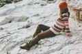 Woman relaxing alone at rocky seaside Travel Lifestyle fashion concept winter vacations outdoor Royalty Free Stock Photo