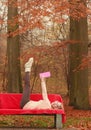 Woman relaxing in autumn fall park reading book. Royalty Free Stock Photo