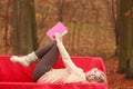 Woman relaxing in autumn fall park reading book. Royalty Free Stock Photo