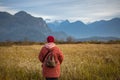 Woman relaxing at autumn landscape. Woman enjoying the view of a mountains at autumn landscape in cloudy day Royalty Free Stock Photo