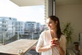 Woman relaxing on balcony holding cup of coffee or tea Royalty Free Stock Photo