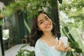 Woman relaxing on balcony holding cup of coffee or tea Royalty Free Stock Photo