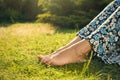 Woman relaxing barefoot on green grass, closeup. Space for text Royalty Free Stock Photo