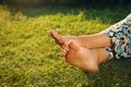 Woman relaxing barefoot on green grass, closeup. Space for text Royalty Free Stock Photo