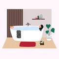 Woman relaxing in bathtub  with bubbles. Young girl taking a bath in  bathroom. Cute interior in trendy Scandinavian style. Royalty Free Stock Photo