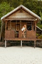 Woman relaxing in beach bungalow at tropical spa resort hotel Royalty Free Stock Photo