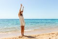 Woman relaxing at beach enjoying summer freedom. Happ girl at the beach