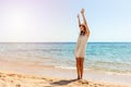 Woman relaxing at beach enjoying summer freedom. Happ girl at the beach