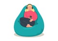 Woman relaxing in bean bag and listenning music or online radio.