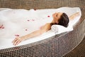 Woman Relaxing in Bubble Bath With Rose Petals. Body Care Royalty Free Stock Photo