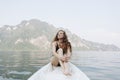 Woman relaxing on a canoe at a lake Royalty Free Stock Photo