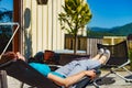 Woman relaxing in chair on veranda