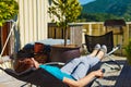 Woman relaxing in chair on veranda