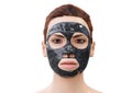 Woman relaxing with a charcoal facial mask Royalty Free Stock Photo