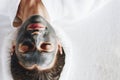 Woman relaxing with a charcoal facial mask Royalty Free Stock Photo
