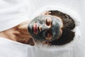 Woman relaxing with a charcoal facial mask Royalty Free Stock Photo