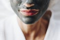 Woman relaxing with a charcoal facial mask Royalty Free Stock Photo