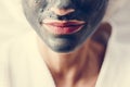 Woman relaxing with a charcoal facial mask Royalty Free Stock Photo