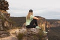 Woman relaxing on the cliffs in the Blue Mountains Royalty Free Stock Photo