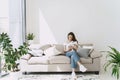 Wwoman relaxing on comfortable couch at home