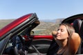 Woman relaxing in a convertible car Royalty Free Stock Photo