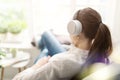 Woman relaxing on the couch and listening to music Royalty Free Stock Photo