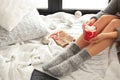 Woman relaxing with cup of hot winter drink on knitted plaid Royalty Free Stock Photo