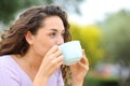 Woman relaxing drinking coffee in a park Royalty Free Stock Photo