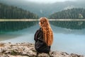 Woman Relaxing and Enjoying Silence by Mountain Lake Royalty Free Stock Photo