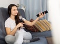 Woman relaxing at evening with glass of red wine on sofa Royalty Free Stock Photo