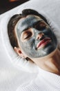 Woman relaxing with a facial mask at the spa Royalty Free Stock Photo