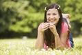 Woman relaxing in field of daisies