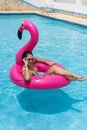 Woman relaxing, floating in inflatable ring in sunny summer swimming pool Royalty Free Stock Photo