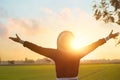 Woman relaxing on green field countryside, pleasant with refreshing air on leisure sunset Royalty Free Stock Photo