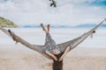 Woman relaxing in the hammock with her feet up in tropical beach on summer vacation. Royalty Free Stock Photo