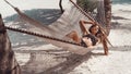 Woman relaxing in the hammock on tropical beach, summer vaction. Free girl chilling on exotic island