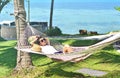 Woman relaxing in the hammock on tropical beach