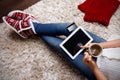 Woman relaxing at home with a cup of tea