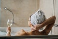 Woman relaxing at home in the hot tub bath ritual,drinking wine.Relaxing spa night in bathroom.Good personal hygiene routine.Skin,