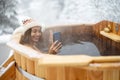 Woman relaxing in hot bath at snowy mountains Royalty Free Stock Photo