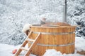 Woman relaxing in hot bath at snowy mountains Royalty Free Stock Photo