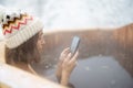 Woman relaxing in hot bath at snowy mountains Royalty Free Stock Photo