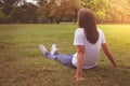 Woman relaxing and lies on green grass in the park.