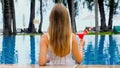 Woman relaxing in luxury beach resort pool, drinking non-alcoholic cocktail Royalty Free Stock Photo