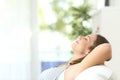 Woman relaxing lying on a couch at home Royalty Free Stock Photo