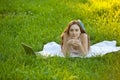 Woman relaxing lying on green grass Royalty Free Stock Photo