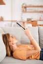 Woman Relaxing Lying On Sofa At Home Looking At Digital Tablet Royalty Free Stock Photo