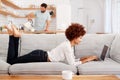 Woman Relaxing Lying On Sofa At Home Looking At Laptop Royalty Free Stock Photo