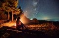 Woman is relaxing near forest in campsite. Royalty Free Stock Photo